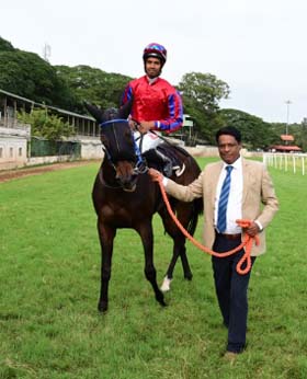 Trainer Bobby M leading Cloudy Hills (K Mukesh Kumar), winner of Talakadu Plate at Mysore on Thursday.